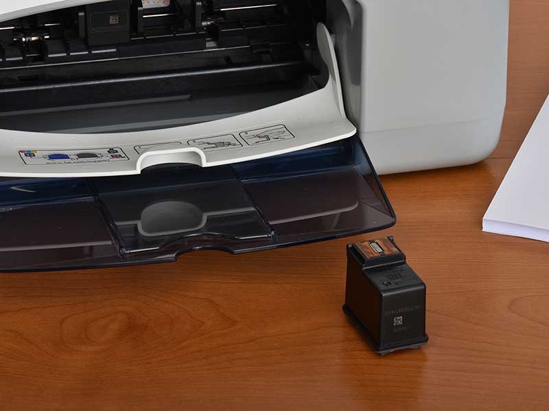 DeskJet printer with print head cartridge removed for cleaning