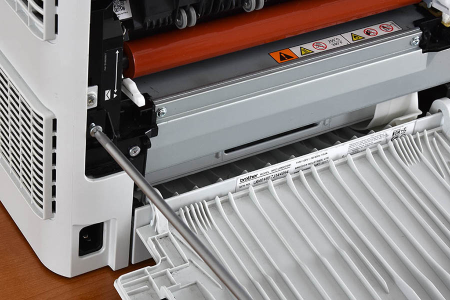 Insert and tighten left fuser cover top screw